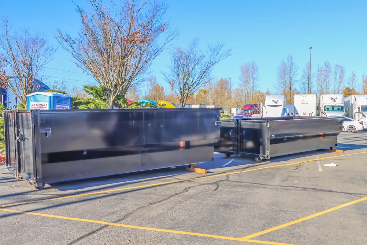 Professional dumpster rental service with roll-off container on residential driveway in Brambleton